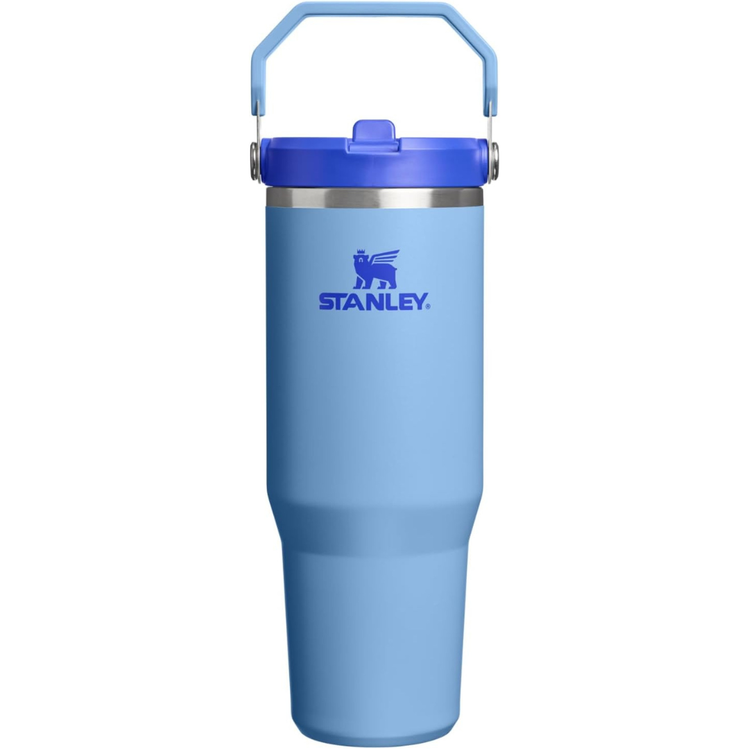Blue Stanley tumbler with a handle on a white background